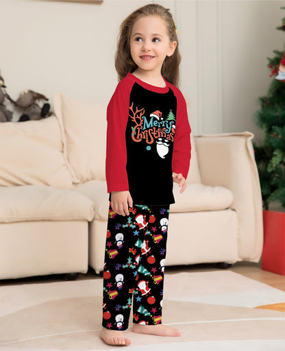 Child wearing Christmas-themed pajamas in a living room setting