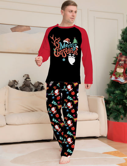 Man wearing Christmas-themed pajamas in a living room with a decorated tree.